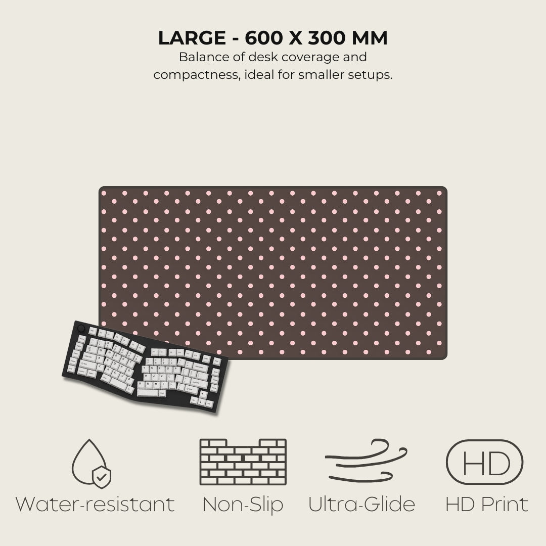 Large desk mat with polka dot pattern and keyboard on a light gray background