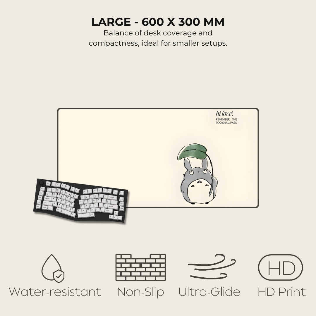Large desk mat with cartoon character, keyboard, and text on a light gray background