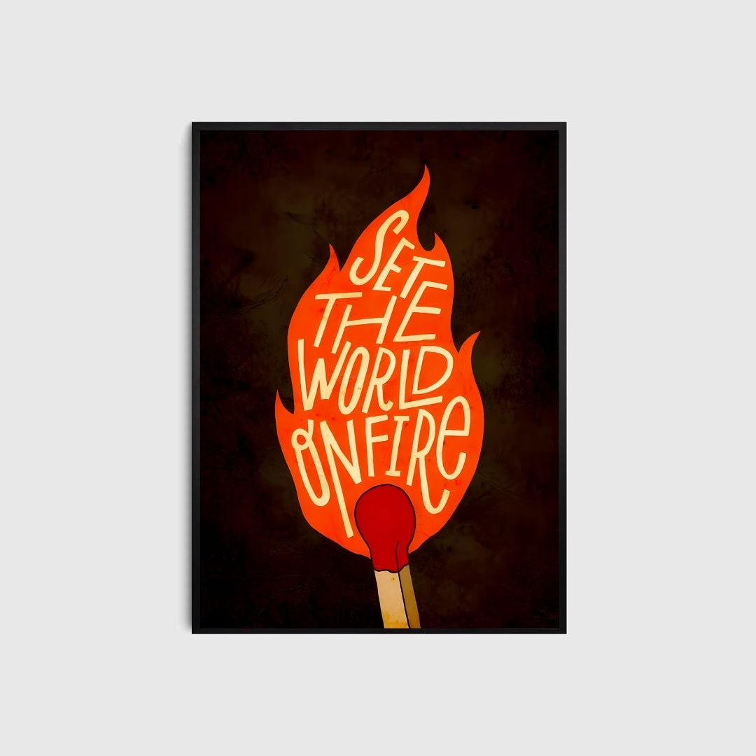 Framed artwork with a match and 'Set the World on Fire' text against a dark background