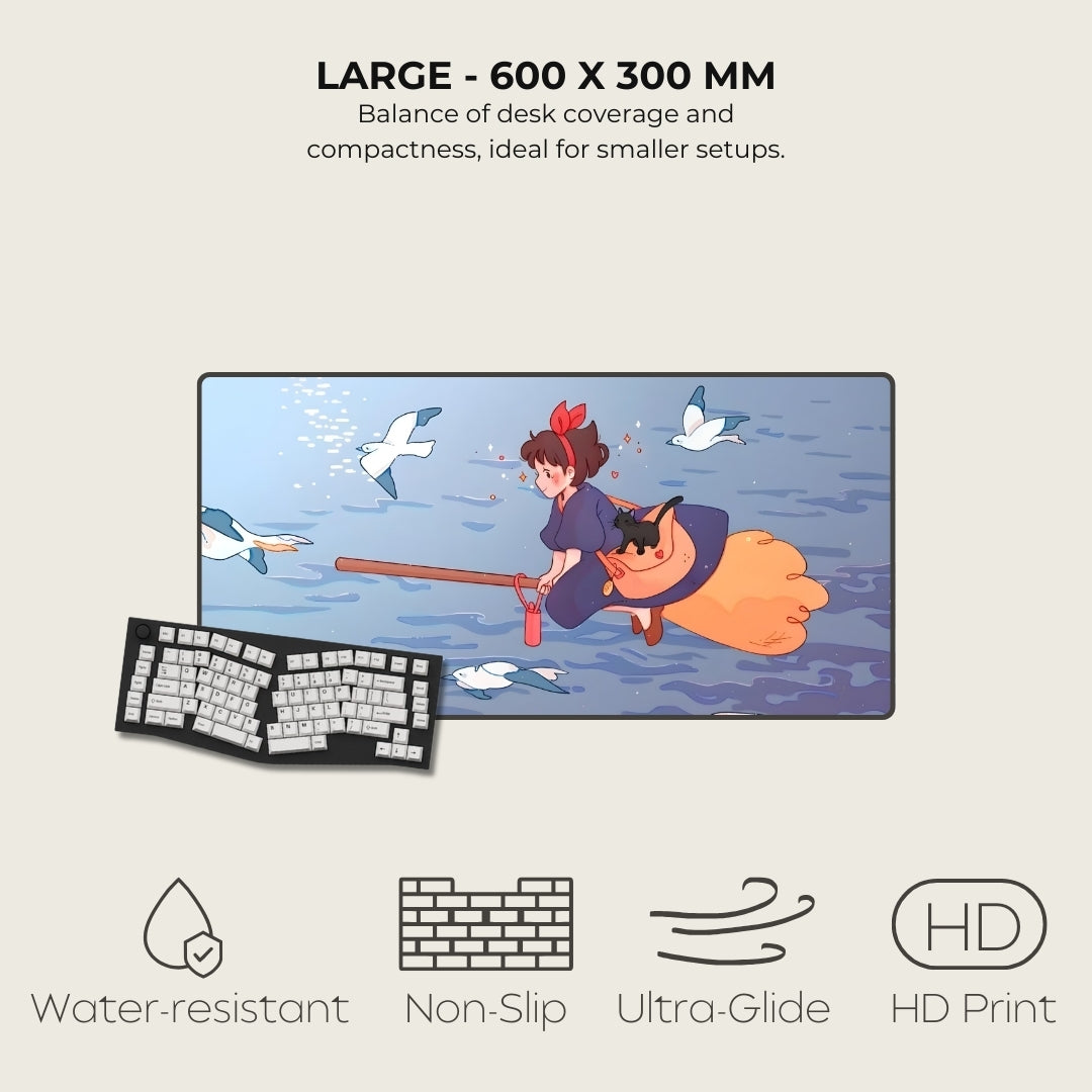 Desk mat with cartoon design of a person on a broomstick with birds, next to a keyboard, on a light gray background.