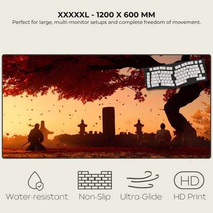 XXXXXL desk mat with scenic design of people sitting under a tree, featuring a keyboard on a sunset background.