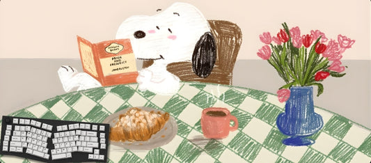 Illustration of a dog reading a book at a table with a cup, pastry, and vase of flowers.