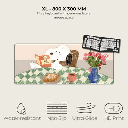 Large mouse pad with cartoon dog, keyboard, and flowers on a checkered tablecloth.