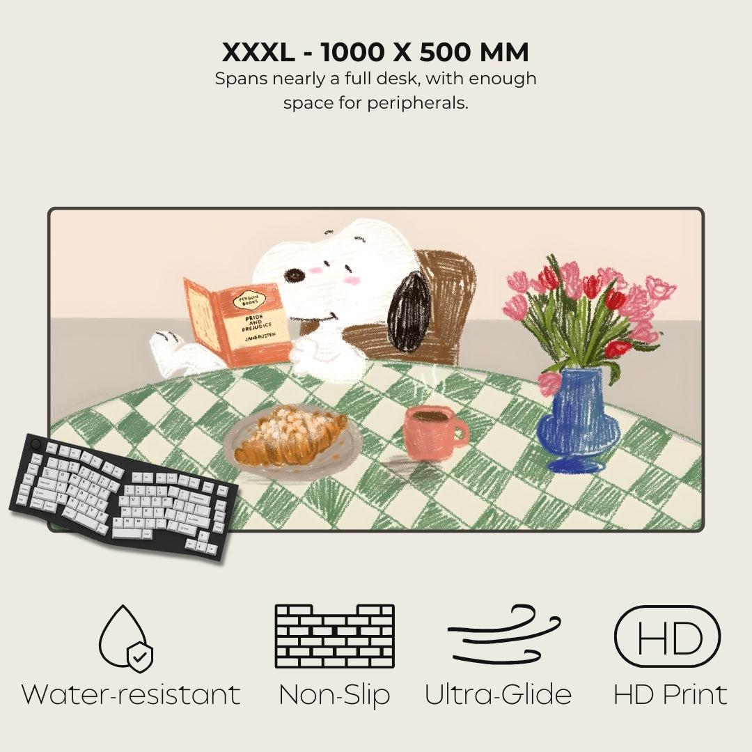 Large desk mat with Snoopy and a checkered pattern, featuring a cartoon dog, bread, coffee, and flowers on a white background.