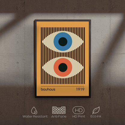 Framed artwork with abstract eyes design on a textured wall.