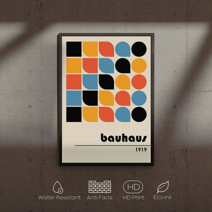 Framed Bauhaus poster with geometric design on a textured wall.