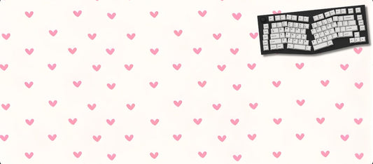 Large mouse pad with pink heart pattern and a keyboard on a white background