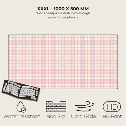 Large desk mat with pink checkered pattern, keyboard on left, text and icons on right.