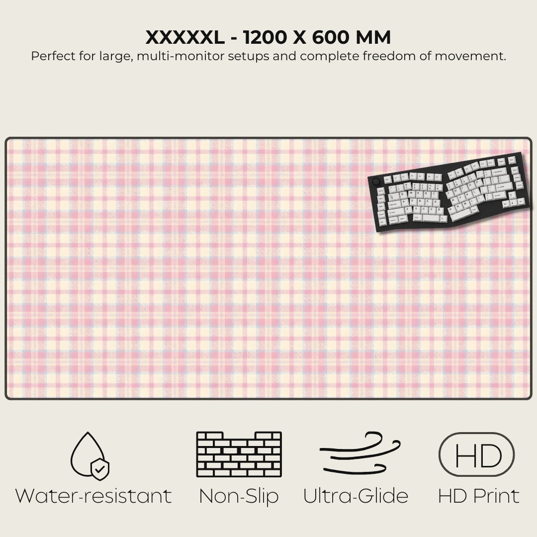 Large pink checkered desk mat with a keyboard on a white background, featuring text and icons about product features.