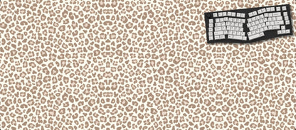 Leopard print desk mat with keyboard and mouse on a black background
