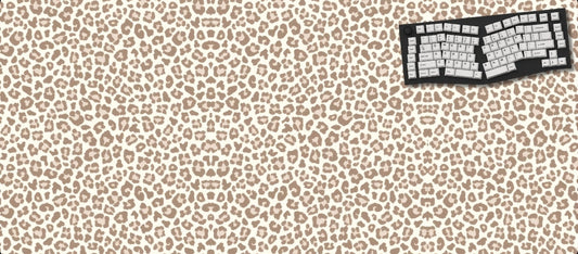 Leopard print desk mat with keyboard and mouse on a black background