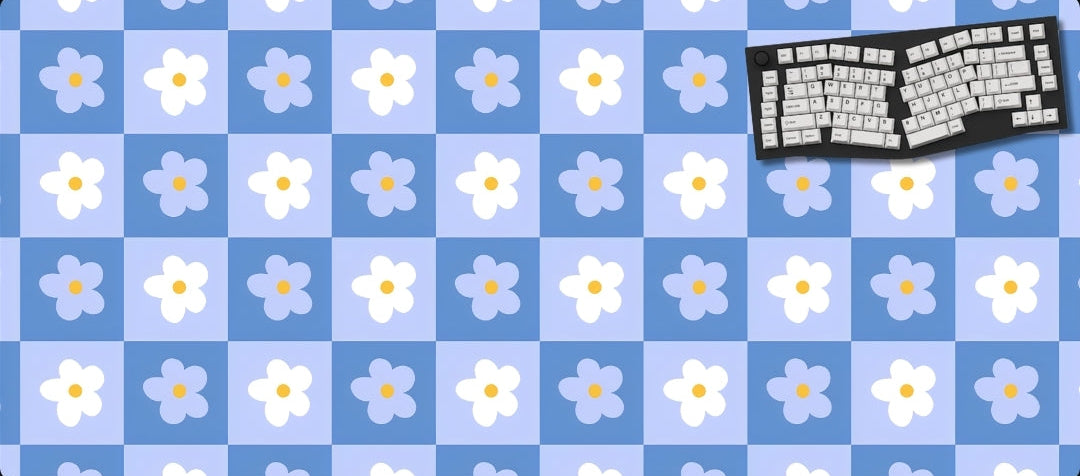 Keyboard on a blue checkered mat with white flowers