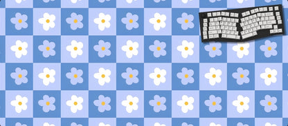 Keyboard on a blue checkered mat with white flowers