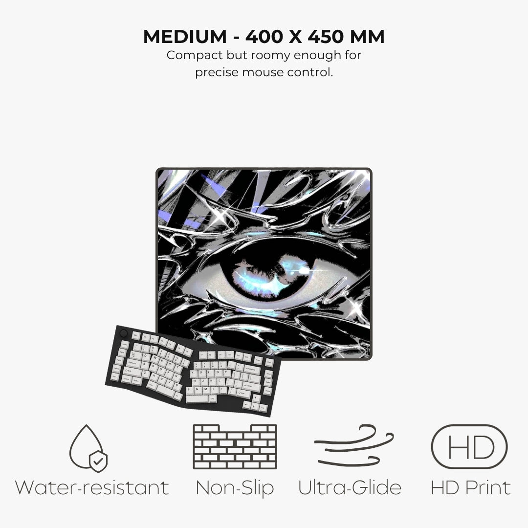 A mouse pad with a glossy black and white abstract eye design, shown with a keyboard on a light gray background. Text at the top reads 'MEDIUM - 400 X 450 MM' and the bottom features feature icons for water-resistant, non-slip, ultra-glide, and HD print.