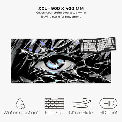 A large rectangular gaming mouse pad with a black, white, and gray anime-style eye graphic, shown on a light gray background with text reading 'XXL - 900 X 400 MM' and feature icons for water resistance, non-slip, ultra-glide, and HD print.