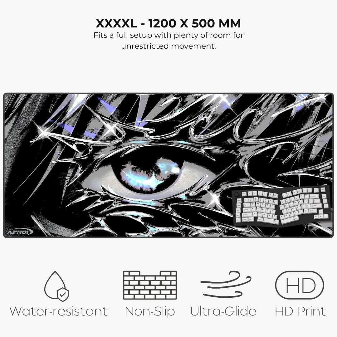 A large rectangular gaming desk mat with a black-and-white anime-style eye graphic and a keyboard shown on top, with text reading 'XXXXL - 1200 X 500 MM' and feature icons for water-resistant, non-slip, ultra-glide, and HD print.