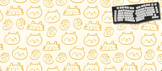 Keyboard on a mouse pad with cat pattern