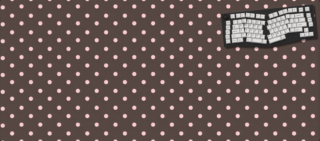 Polka dot mouse pad with keyboard on a dark background