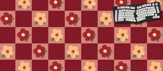 Checkered mat with floral patterns and a keyboard on a dark background