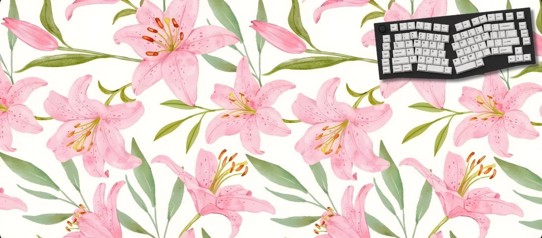 Floral desk mat with pink lilies and green leaves, featuring a keyboard on a white background.