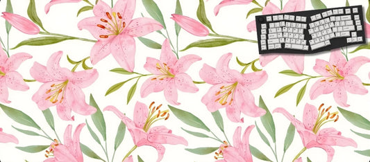 Floral desk mat with pink lilies and green leaves, featuring a keyboard on a white background.