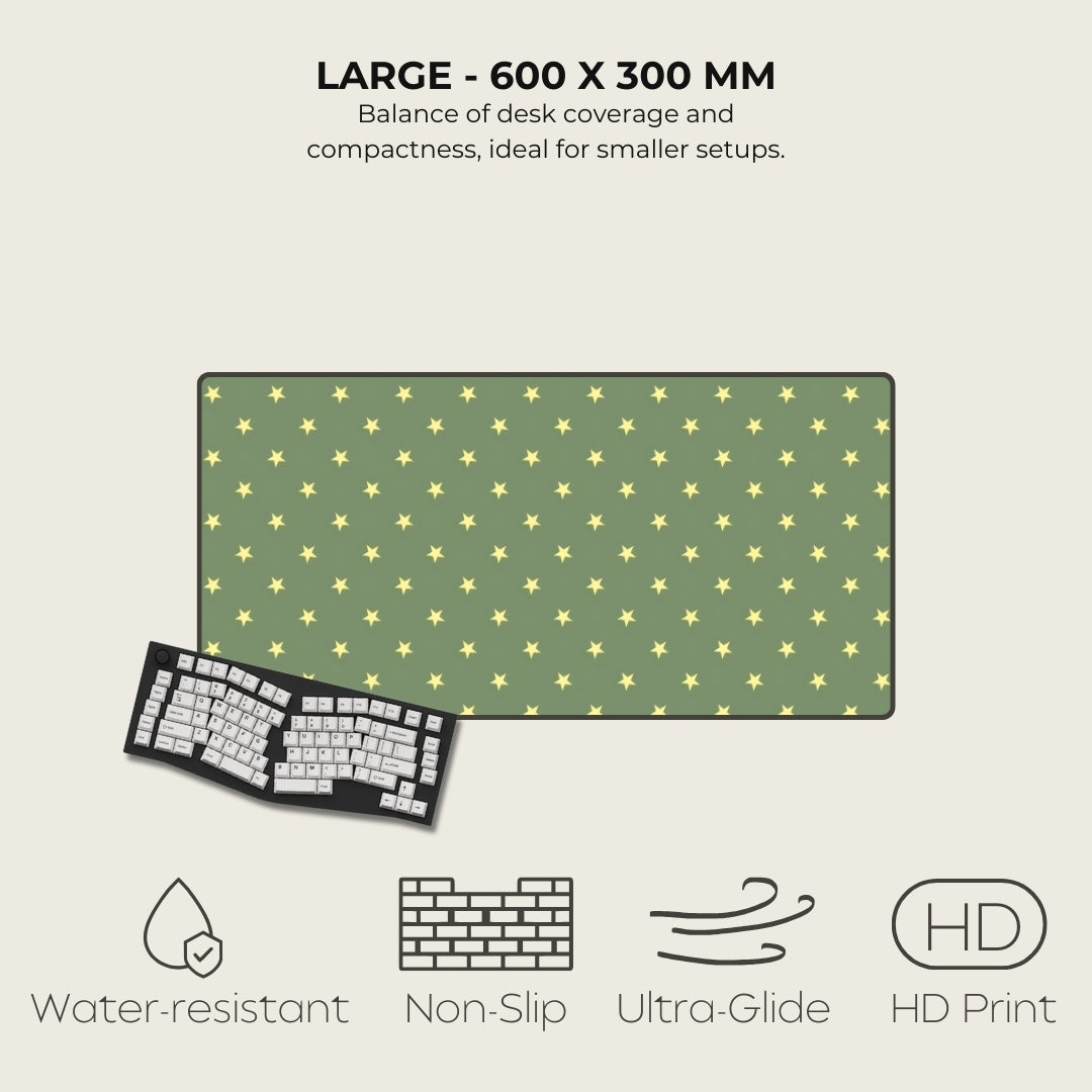 Green desk mat with yellow star pattern and keyboard on a light beige background