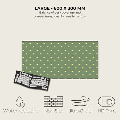 Green desk mat with yellow star pattern and keyboard on a light beige background