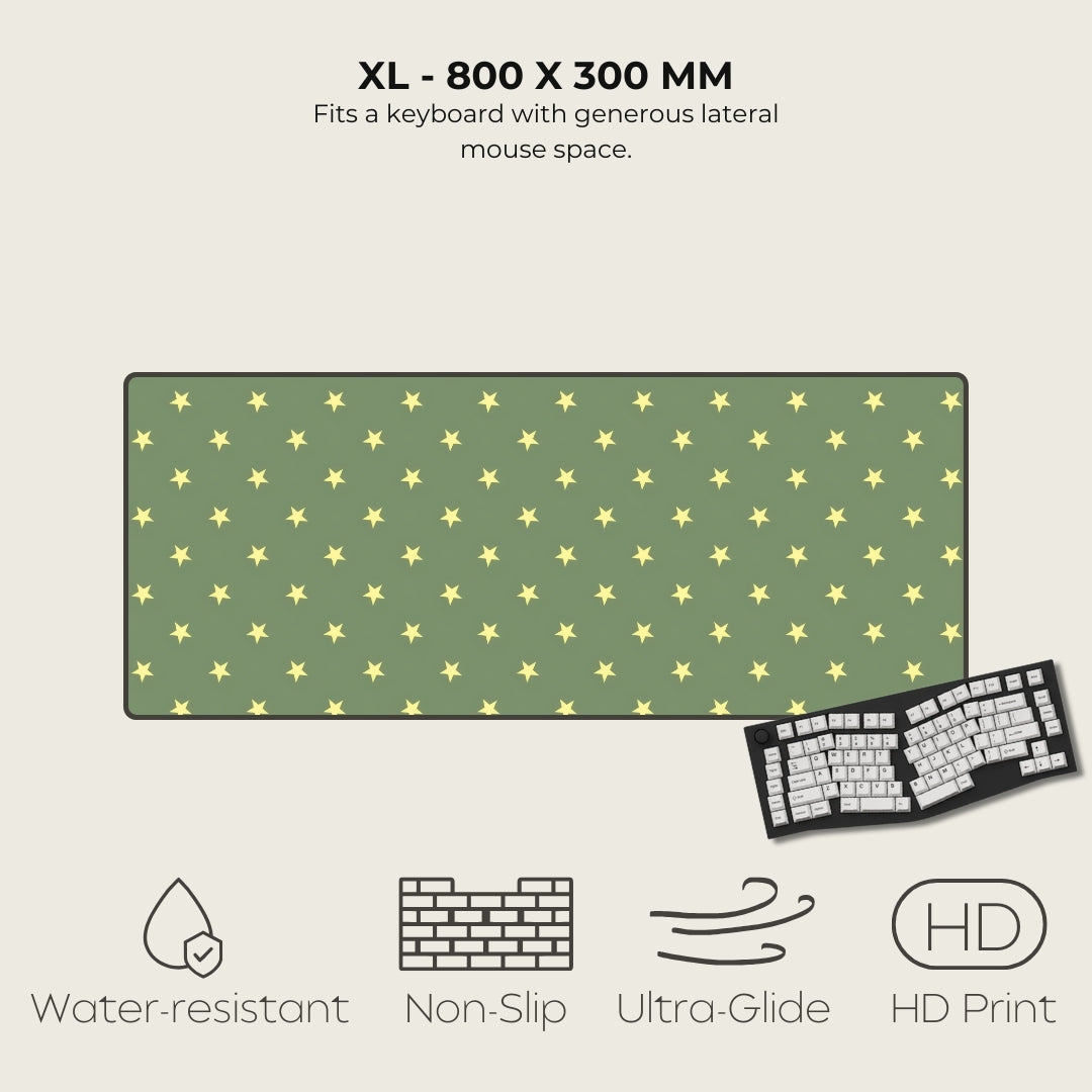 Green mouse pad with yellow star pattern and keyboard on a beige background