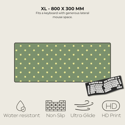 Green mouse pad with yellow star pattern and keyboard on a beige background