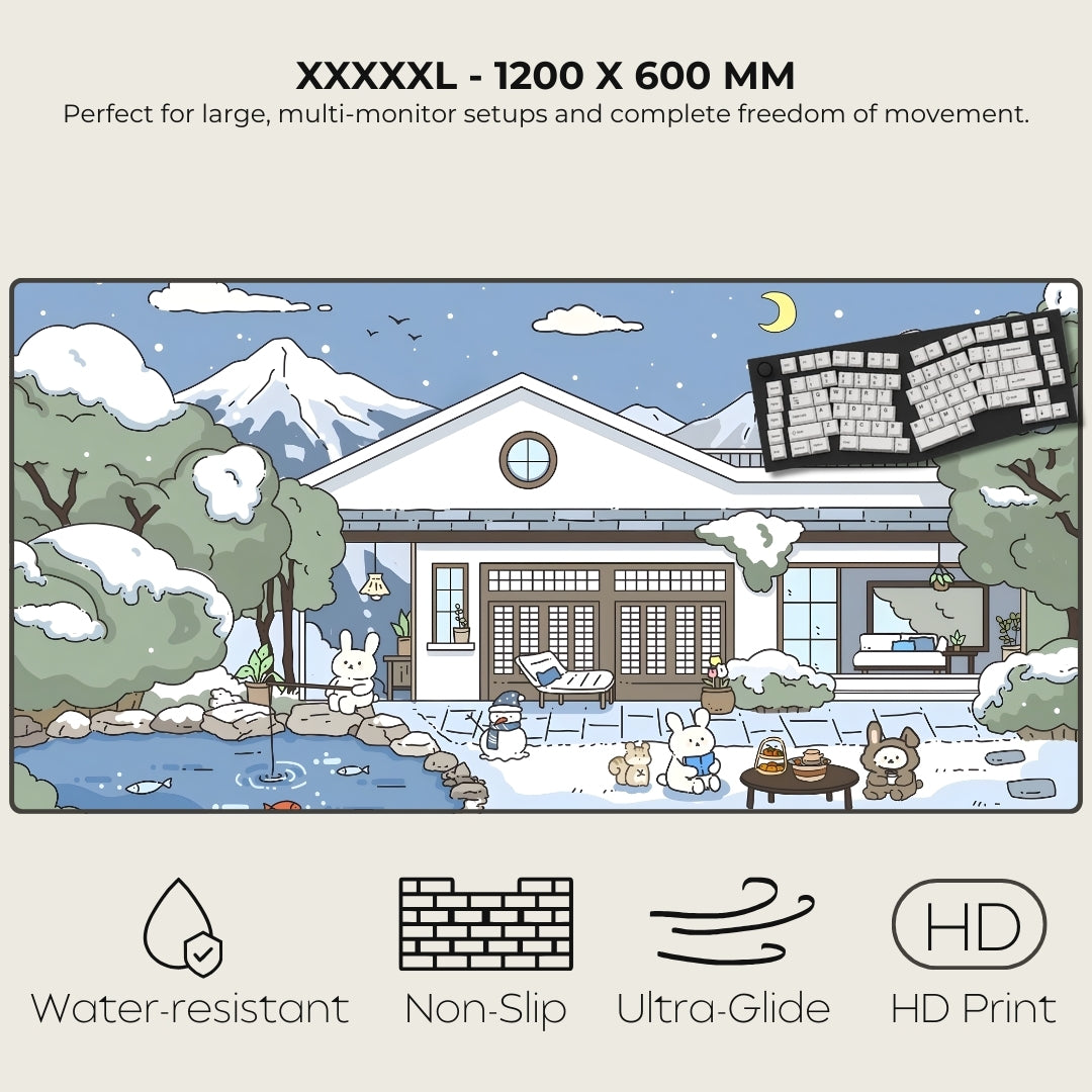 Large monitor desk mat with a snowy house and animals design, featuring text and icons indicating product features.