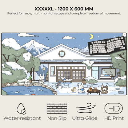 Large monitor desk mat with a snowy house and animals design, featuring text and icons indicating product features.