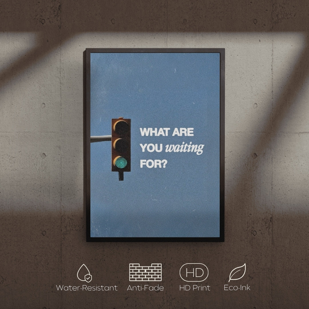 Framed poster with a traffic light and motivational text on a blue background, mounted on a textured wall.