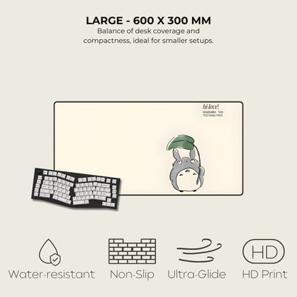 Large desk mat with cartoon character, keyboard, and text on a light gray background