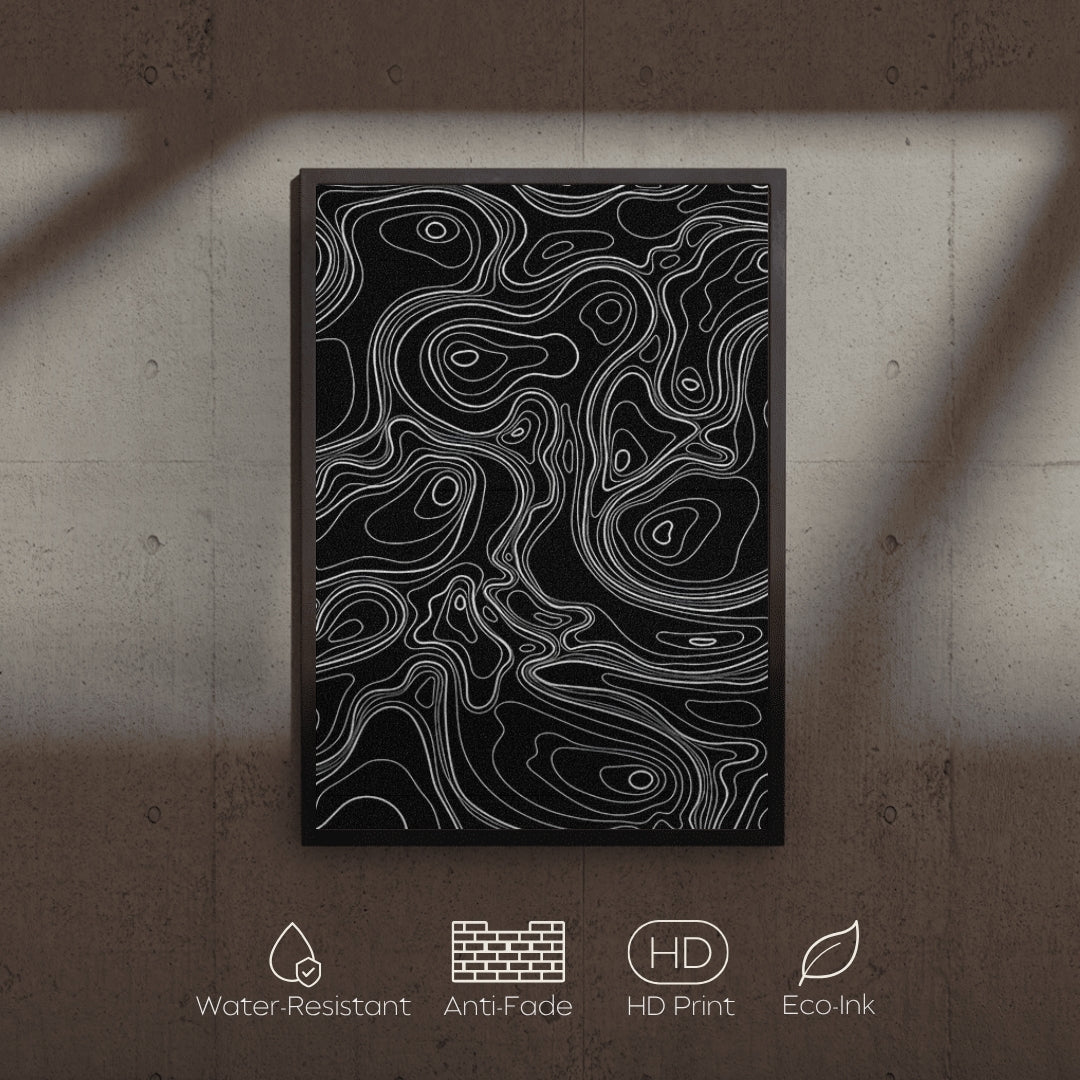 Abstract art print with white lines on a black background, displayed on a textured wall.