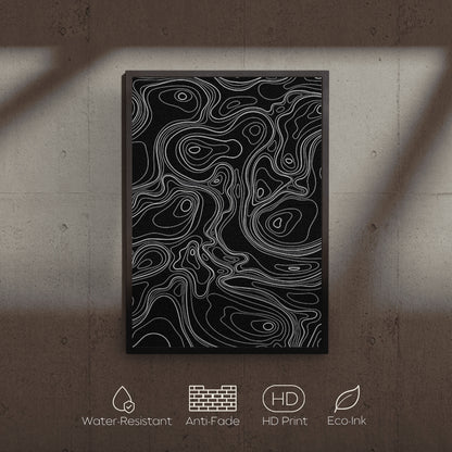 Abstract art print with white lines on a black background, displayed on a textured wall.
