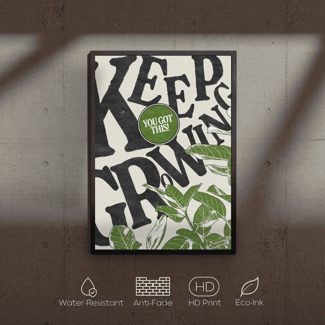 Framed poster with motivational quote and green leaves on a textured wall.