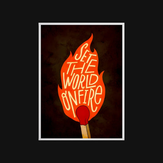 Flame-shaped sign with 'Set the World on Fire' text and a match below on a dark background