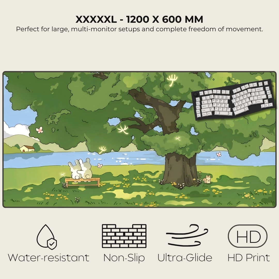 Large mouse pad with nature design, keyboard, and cartoon character under a tree.
