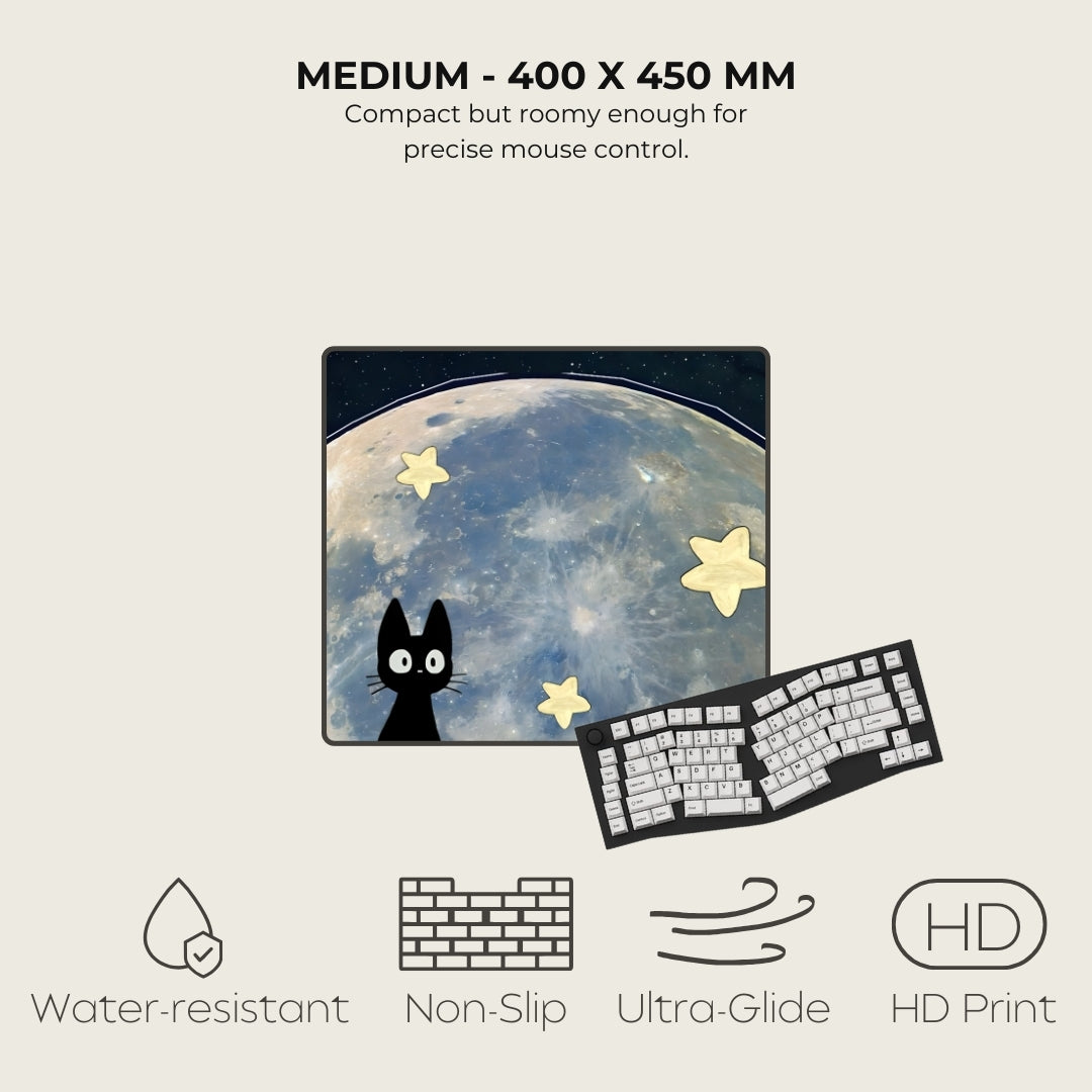 Mouse pad with a cat and star design, next to a keyboard, on a light beige background.