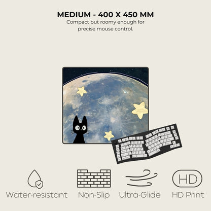 Mouse pad with a cat and star design, next to a keyboard, on a light beige background.