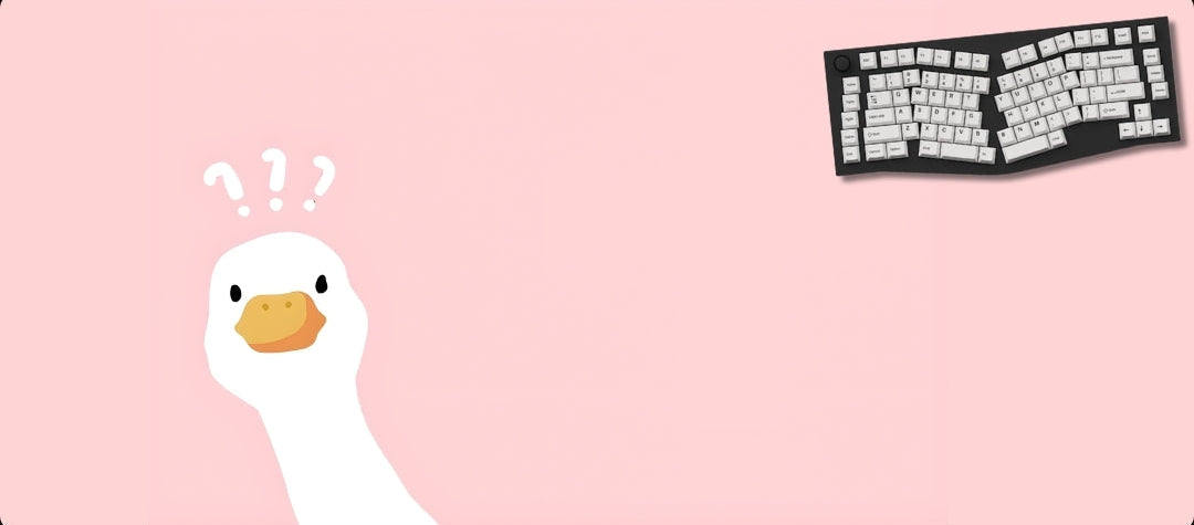 Pink mouse pad with cartoon duck and keyboard design on a black background