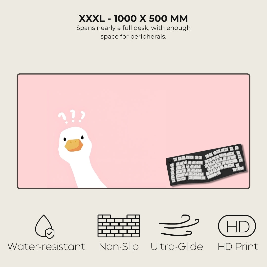 Large pink desk mat with a cartoon duck and keyboard illustration, featuring product specifications and features.