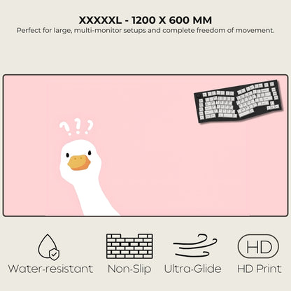 Large pink desk mat with a cartoon duck and keyboard illustration, featuring text about size and properties.