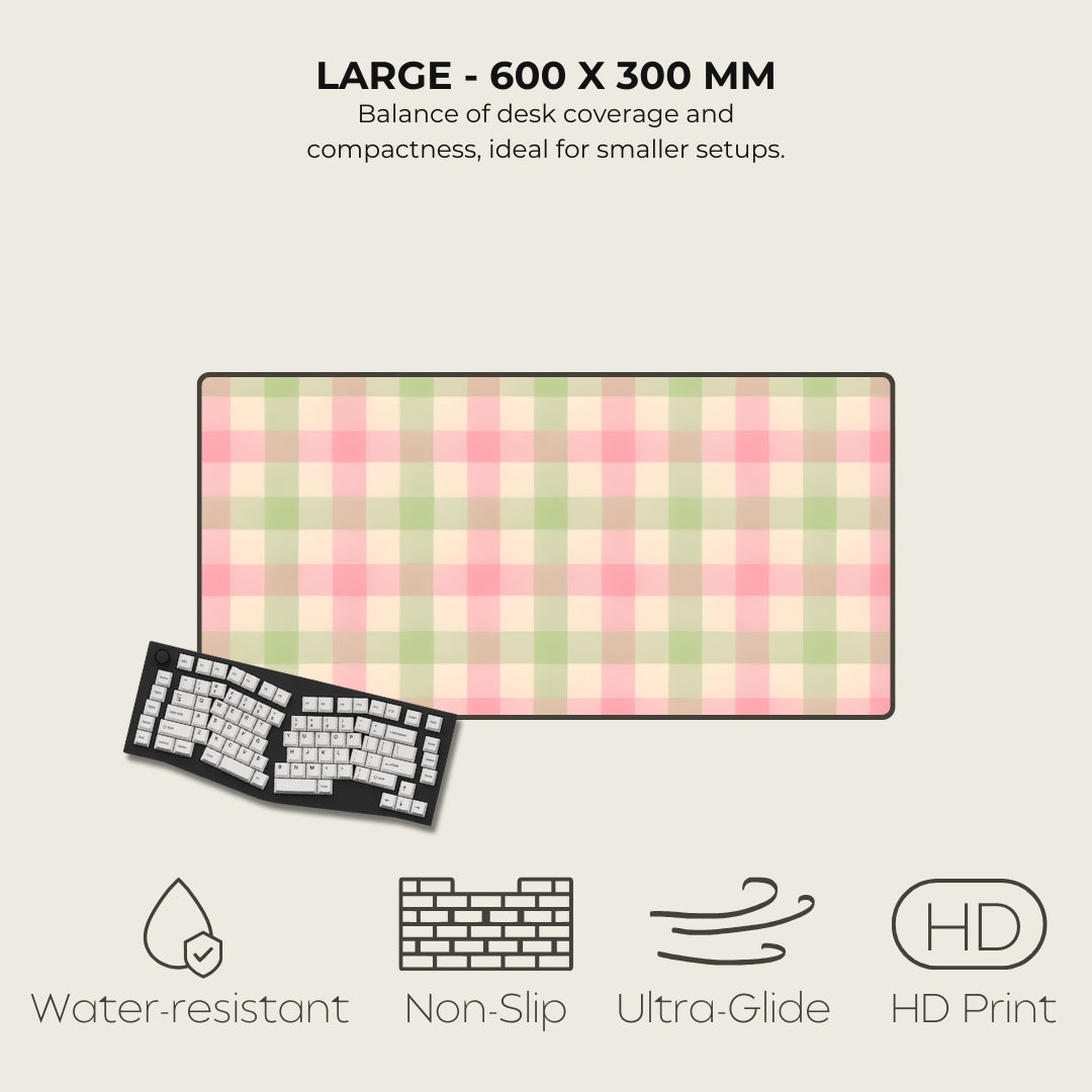 Large desk mat with pink and green checkered pattern, keyboard on the side, and feature icons below.