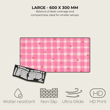 Pink checkered desk mat with keyboard on a light gray background, featuring text and icons about product features.