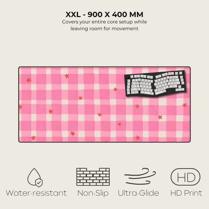 Pink checkered mouse pad with keyboard graphic on a light gray background