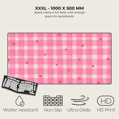 Pink checkered desk mat with star patterns, keyboard on the side, and feature icons below.