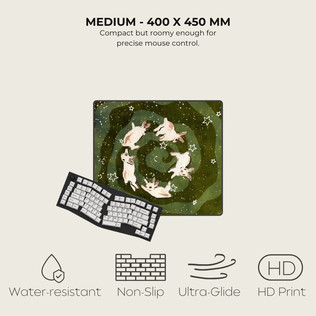 Mouse pad with a design of dogs in a circle, next to a keyboard, on a light beige background.