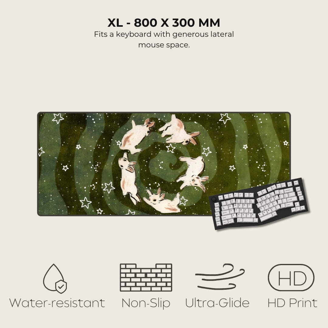 Large mouse pad with a design of cats in a spiral pattern, next to a keyboard. Features listed include water-resistant, non-slip, ultra-glide, and HD print.