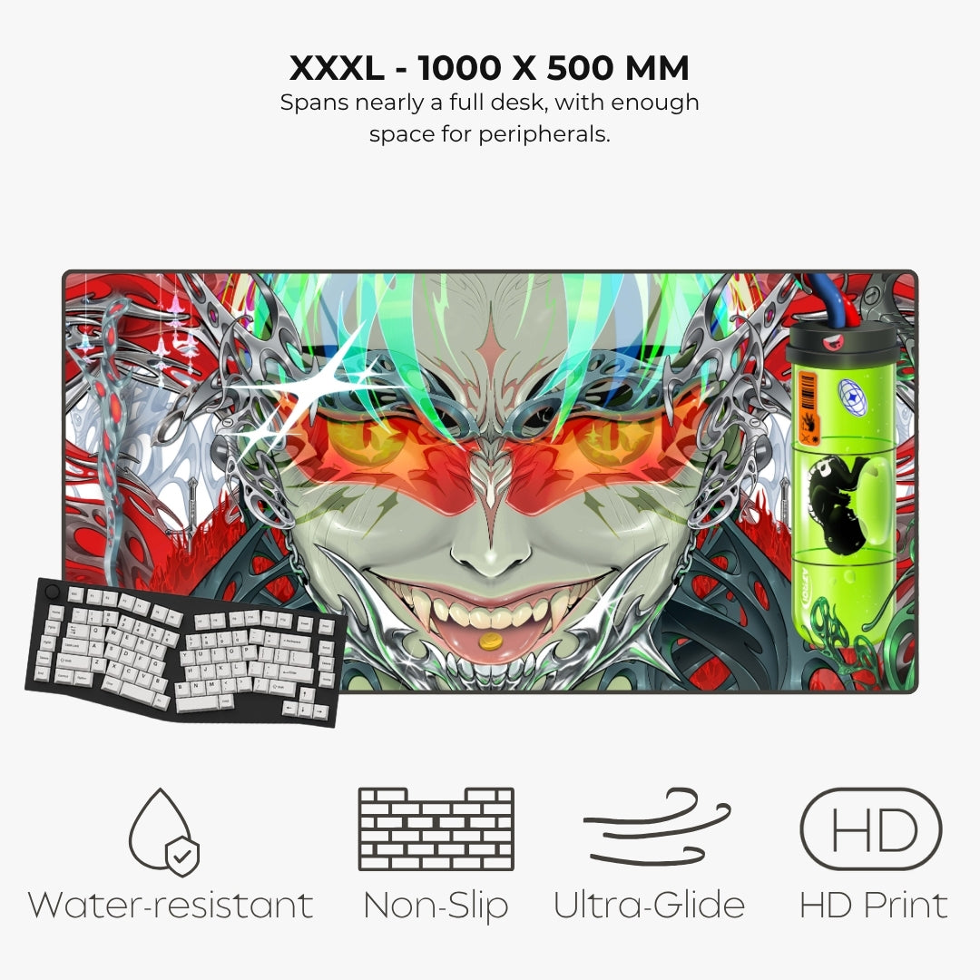 A large gaming desk mat with a detailed anime-style monster face graphic, shown on a light gray background with text describing its 1000 x 500 mm size and feature icons for water resistance, non-slip, ultra glide, and HD print. A keyboard and a green mouse are also pictured as styling props.